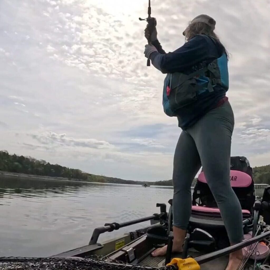 Mandie casting from her kayak at sunset